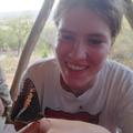 A student with a butterfly on her hand