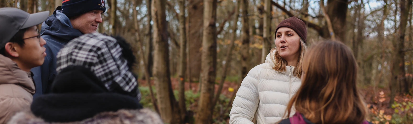 people talk with each other in a woodland
