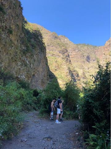 Students look up with cliffs around them