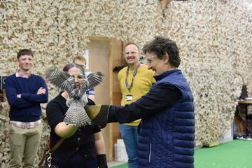 An owl lands on the arm of the Vice-Chancellor, Irene Tracey in the flight lab. 