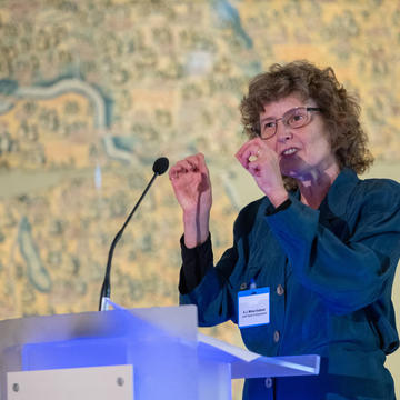 E J Milner-Gulland delivers a speech at a lectern